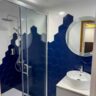A modern and clean design bathroom with blue-white tiles that gives a classic ambience to ensures the comfort of our guests.