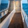 A serene path with wooden details and stunning views of the ocean from our Dune Black Manta Liveaboard.