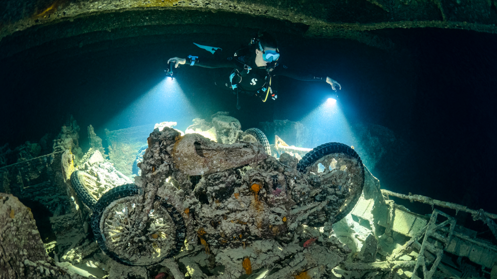 People see an abandoned motorcycle while diving in the Red Sea