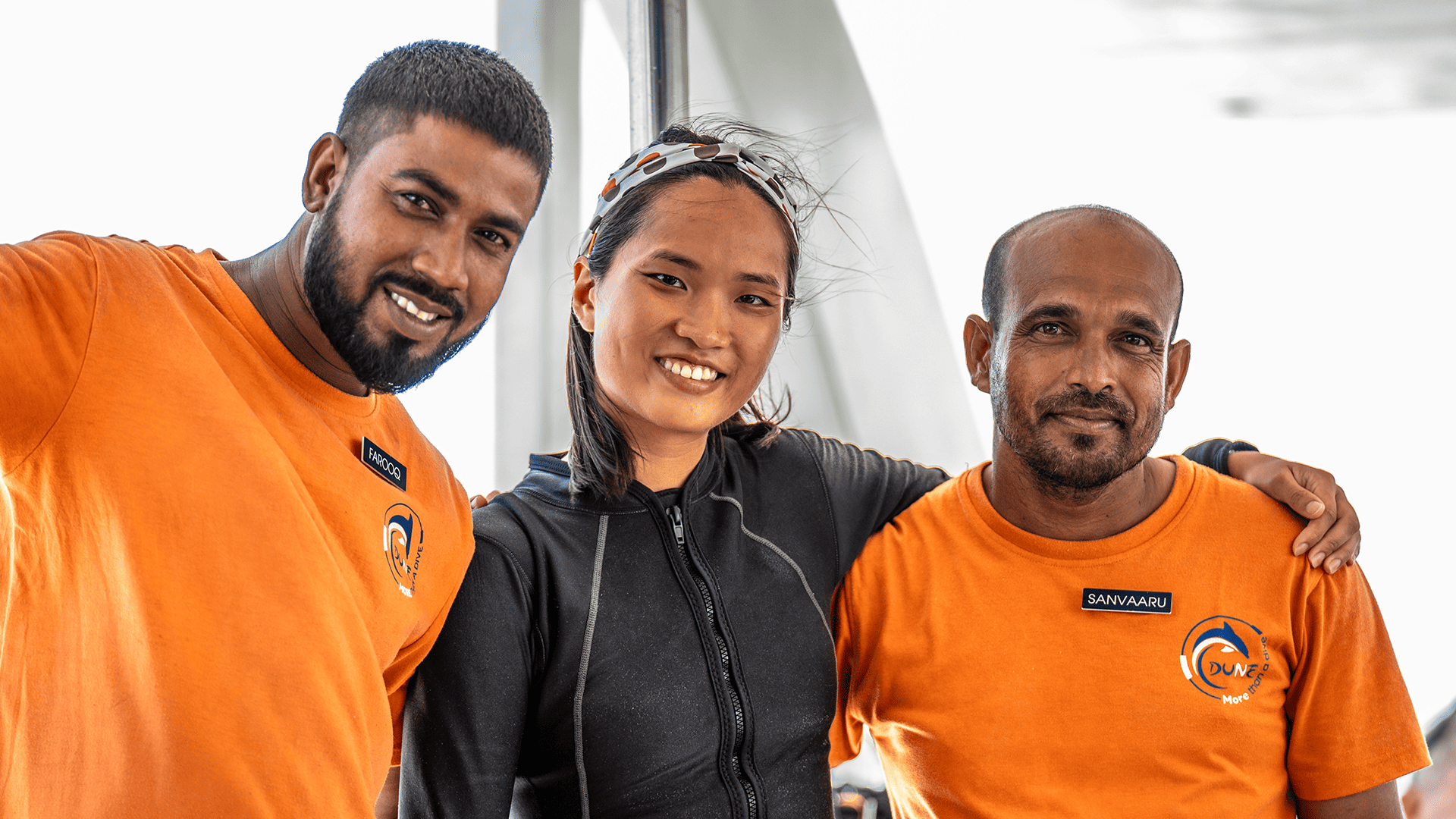 The DUNE Liveaboard Maldives staff are smiling together on board the ship